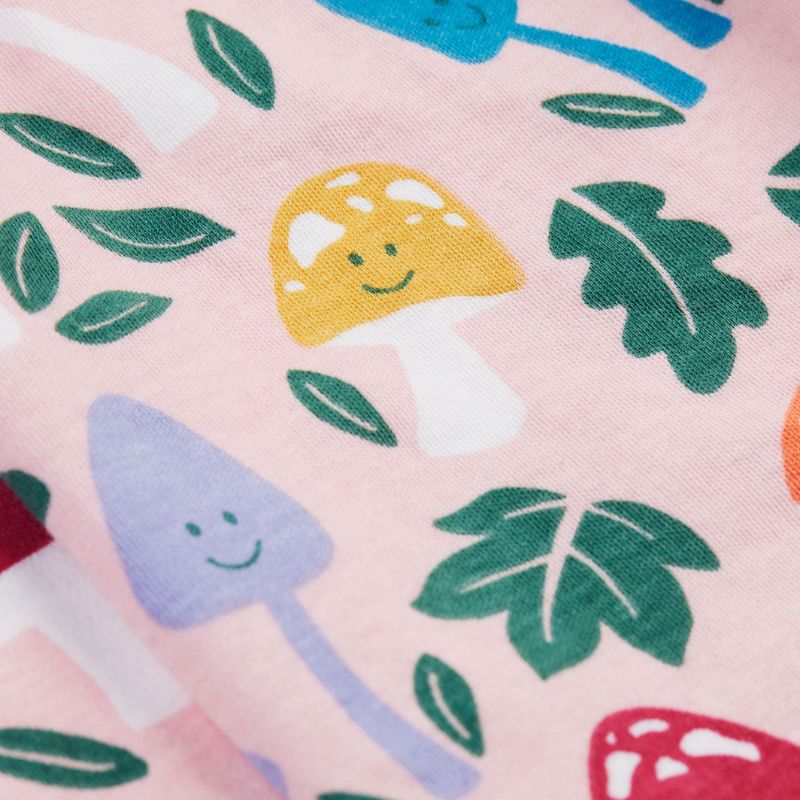Fabric with colorful mushroom and leaf pattern on a pink background
