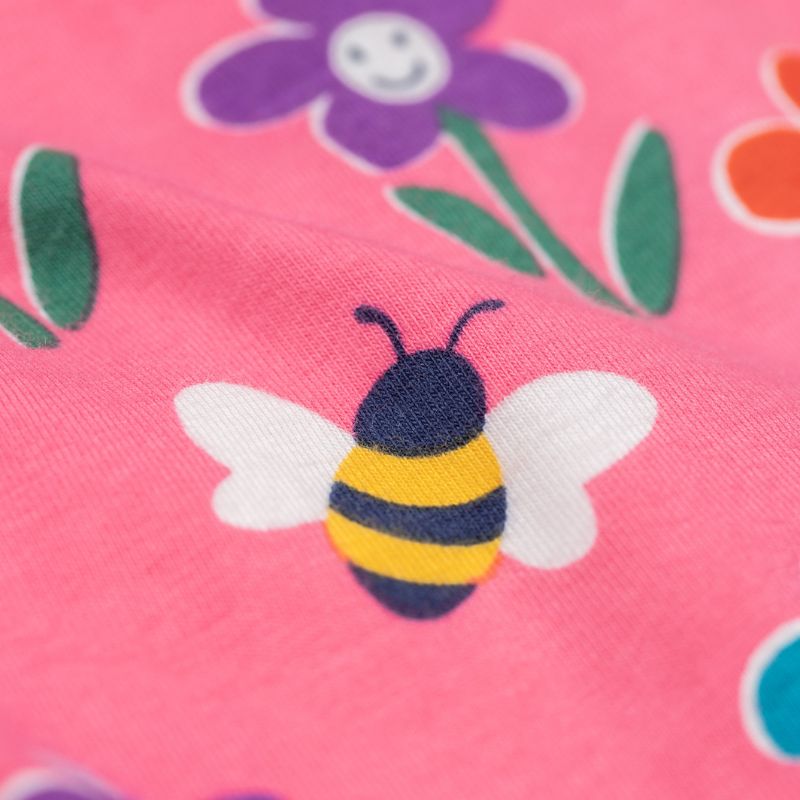 Close-up of a bee and flower pattern on pink fabric
