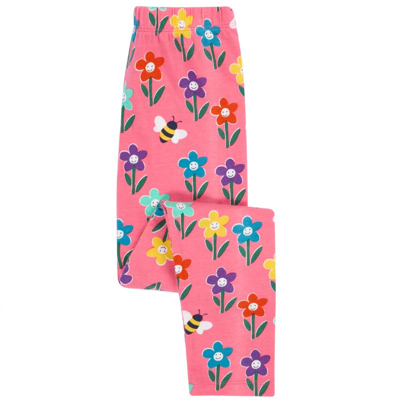 Pink leggings with colorful floral and bee pattern on a white background