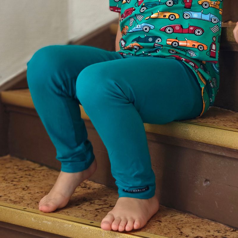 Teal green leggings with a visible Villervalla brand label on a white background